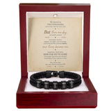 A black braided bracelet with engraved letter beads spelling 'LOVE' and 'FATE', presented inside a dark red wooden gift box with a white insert and a sentimental poem printed on the back.
