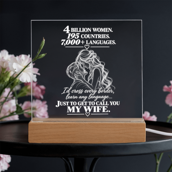 A rectangular acrylic LED light box with a wooden base, featuring a white graphic of a woman and the text '4 BILLION WOMEN. 195 COUNTRIES.