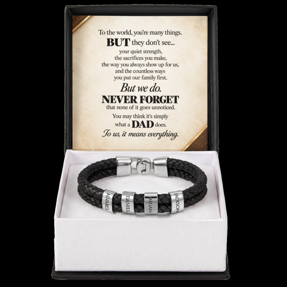 A black braided leather bracelet with silver metal beads and engraved name plates, presented in a white gift box with a black outer sleeve. The inside sleeve features a printed message card for Father's Day.