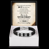 A black braided leather bracelet with silver metal beads and engraved name plates, presented in a white gift box with a black outer sleeve. The inside sleeve features a printed message card for Father's Day.