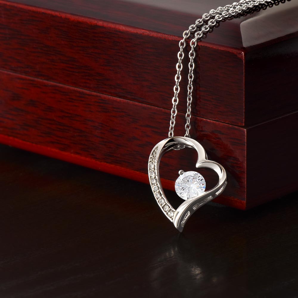 close up of white gold forever love necklace