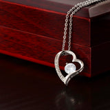 close up of white gold forever love necklace