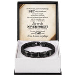 A black braided cord bracelet with silver-toned letter beads spelling out 'I LOVE DAD', presented in a white gift box with a black outer frame. The inside lid features a sentimental message for Dad printed in black text on a beige background.