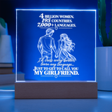 A rectangular LED lamp on a wooden base displaying a romantic message in white text and a couple holding hands, glowing with a blue light in a softly lit room.