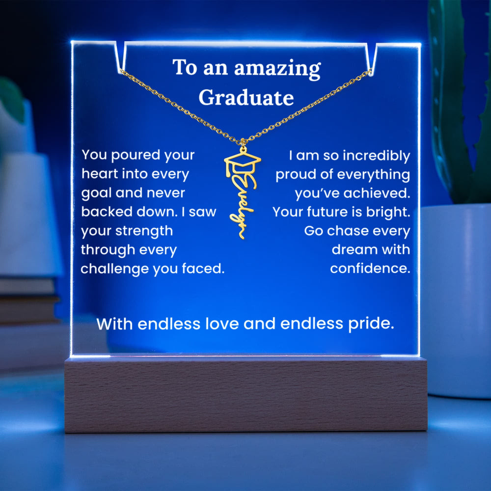 Decorative plaque with a necklace pendant and graduation-themed text on a blue background