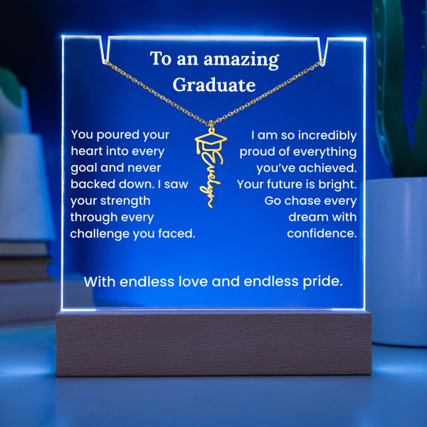Decorative plaque with a necklace pendant and graduation-themed text on a blue background