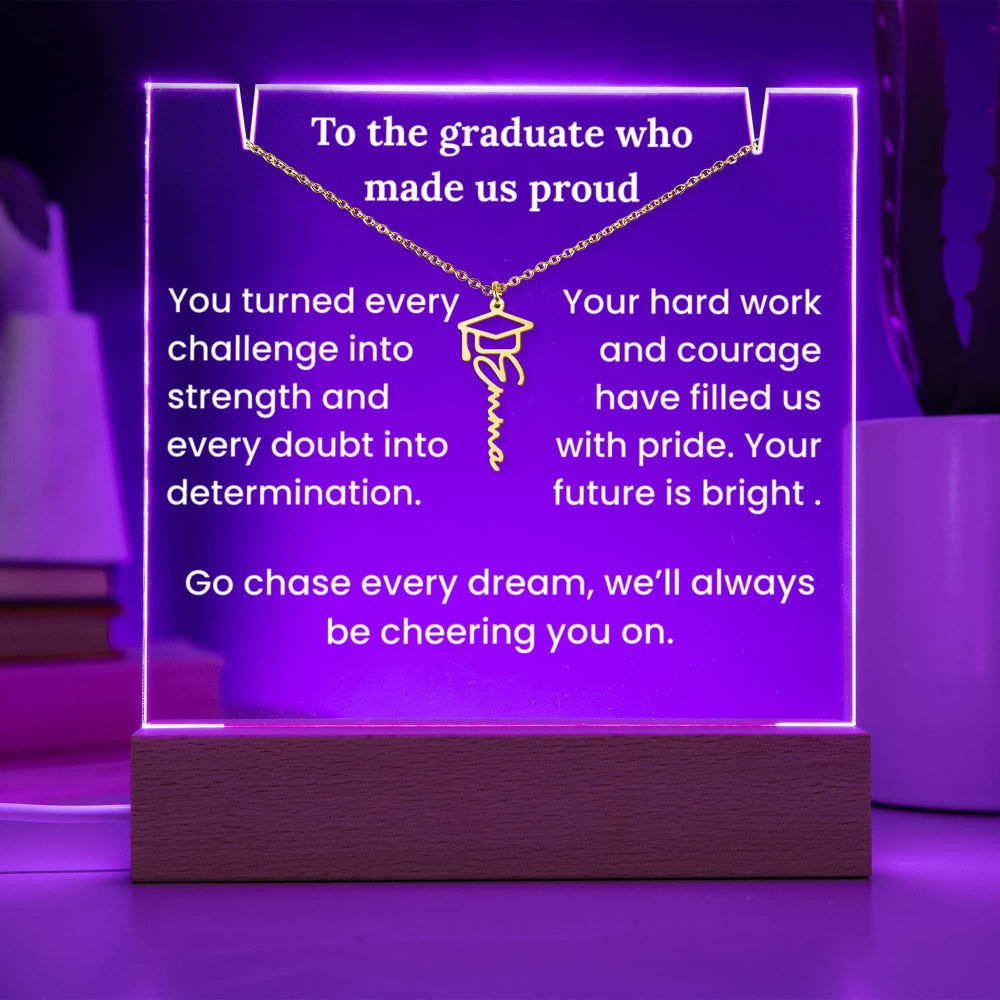 Decorative plaque with  text and a graduation cap symbol, illuminated with purple light.