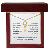 Gold necklace in a jewelry box with a sentimental message card.