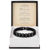 A black beaded bracelet with silver letter beads spelling 'LOVE' across multiple links, presented in a white box with a black outer base. The box is open to show a sentimental message card inside.