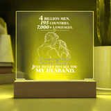 A rectangular acrylic LED night light with a wooden base, glowing with a warm yellow light. The front features a white laser-engraved illustration of a couple from behind, surrounded by small hearts, with romantic text that reads, 'I CHOSE YOU without knowing where life would take us.