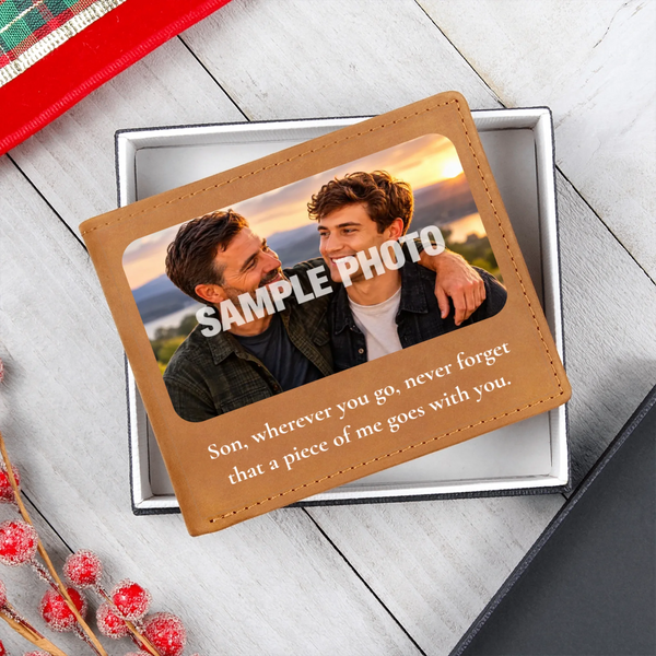 A custom photo wallet card with a tan faux-leather border, displayed inside a silver gift box on a light gray wood background. The card features a customizable sample photo of a young man and a sentimental message for 'Son'.