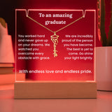 Necklace with a graduation cap pendant on a red background with text