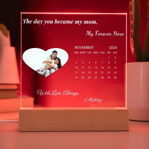 Personalized calendar with a photo of a mother and child, text 'My Forever Hero', and a wooden base on a red background.