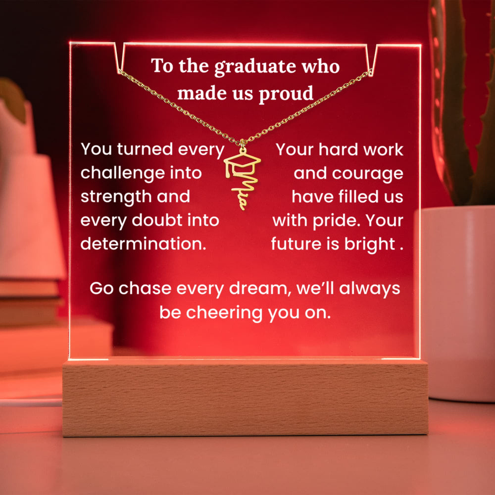 Decorative plaque with a graduation cap design and motivational text on a wooden base.