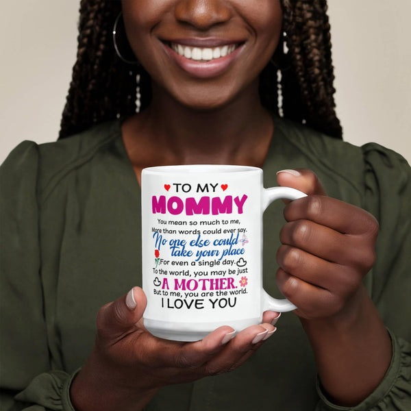 Person holding a 15oz  mug with a heartfelt message to 'My Mommy' against a neutral background