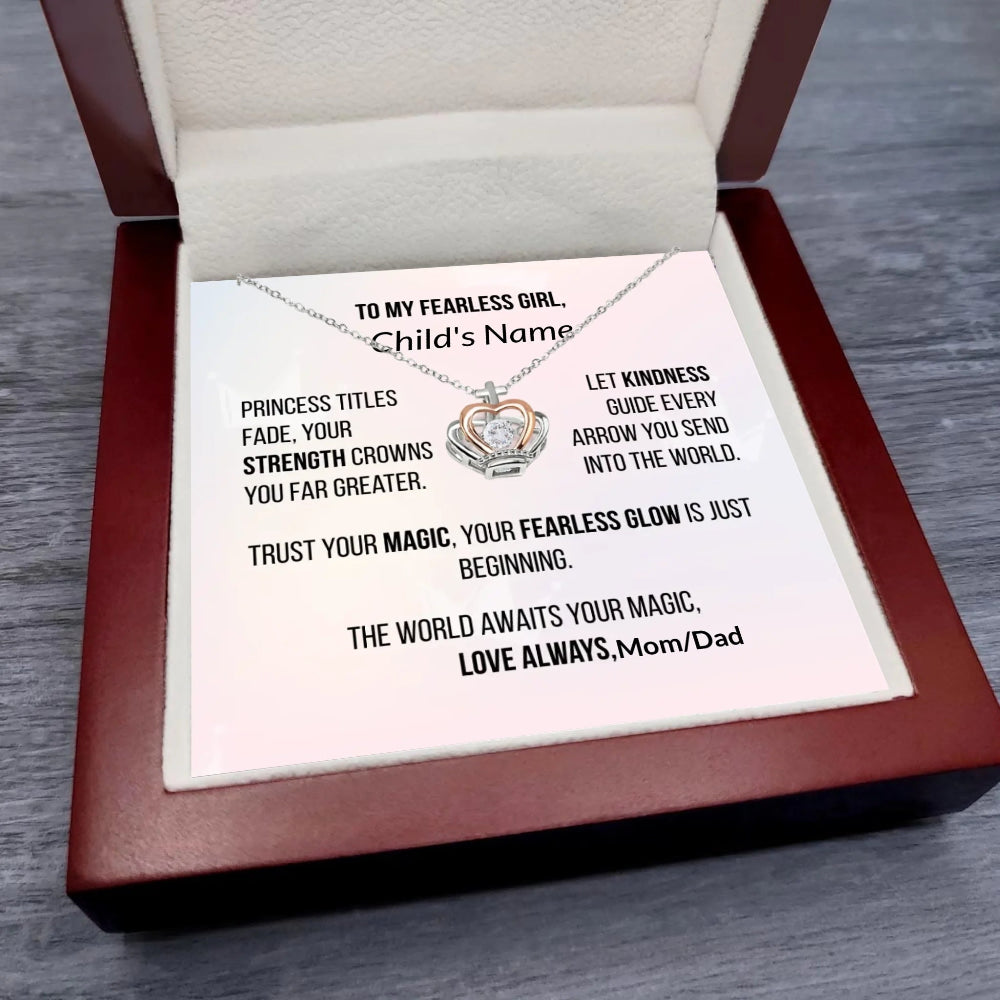 Necklace with engraved message in a wooden box on a wooden surface