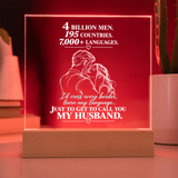 A rectangular acrylic LED light sign on a wooden base, glowing red with white text that reads, '4 BILLION MEN, 195 COUNTRIES, 7,000+ LANGUAGES. I'd cross every border, learn any language.