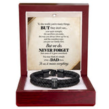 A black braided cord bracelet with a silver-toned metal clasp engraved with 'DAD', presented inside an open dark red wooden gift box. The box features a white insert with a sentimental poem for Dad printed on it.