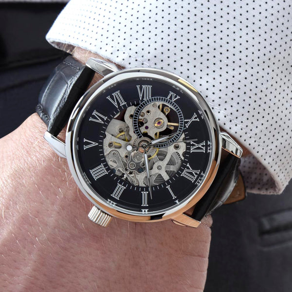 Men's skeleton watch with genuine black leather strap shown naturally on the wrist