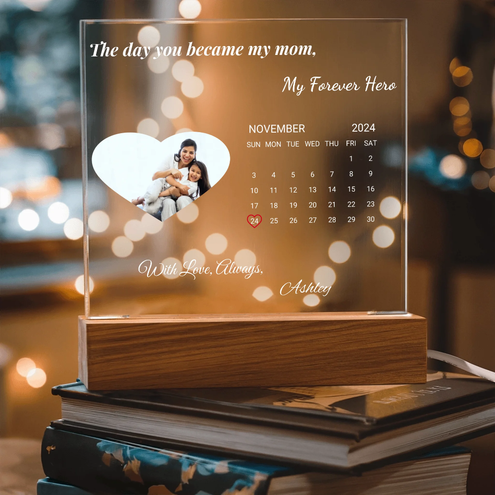 Personalized calendar with a heart-shaped cutout featuring a couple, surrounded by blurred lights.
