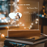 Personalized calendar with a heart-shaped cutout featuring a couple, surrounded by blurred lights.