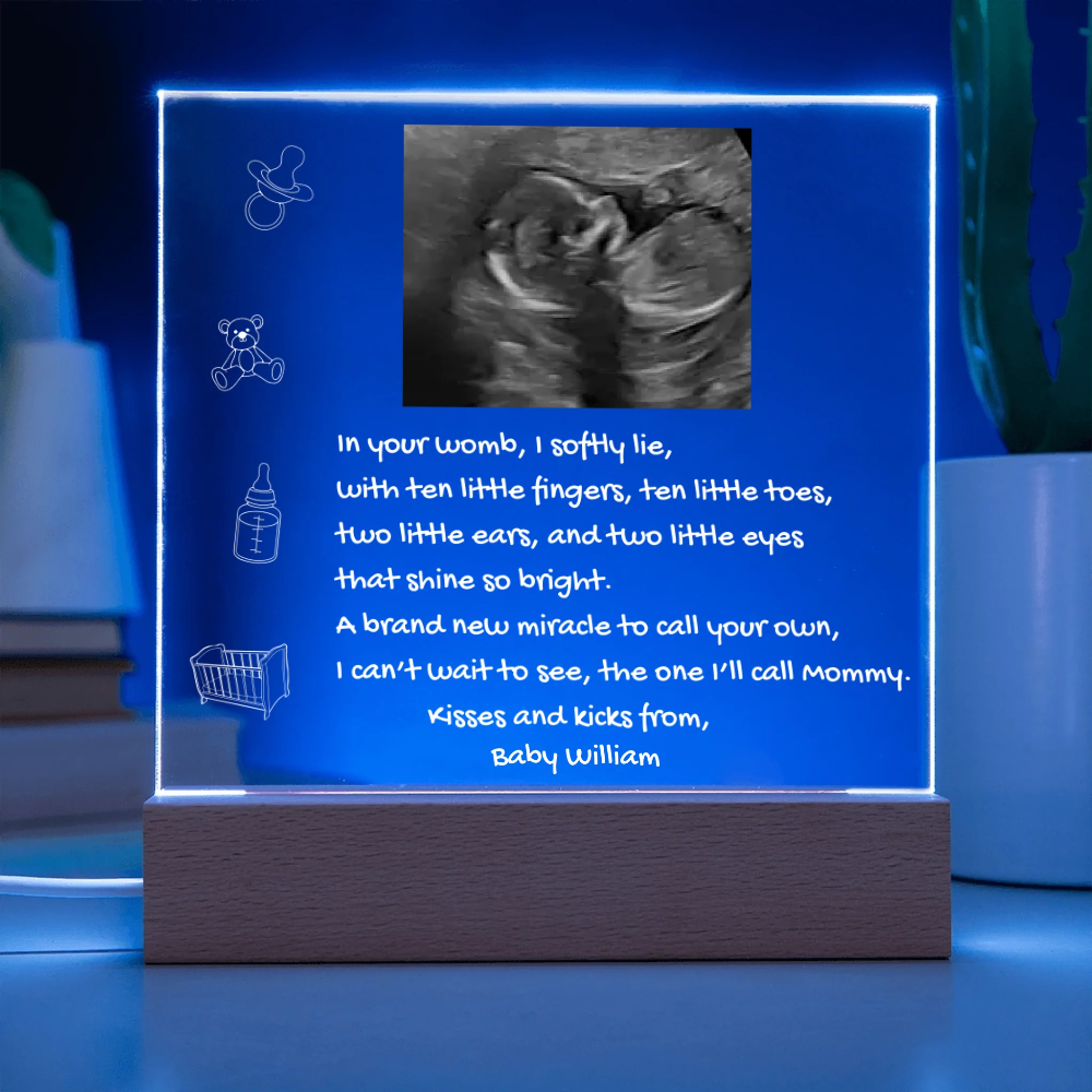 Fetal ultrasound in a illuminated frame with text on a blue background