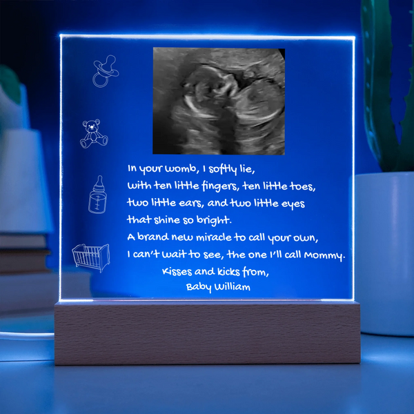 Fetal ultrasound in a illuminated frame with text on a blue background