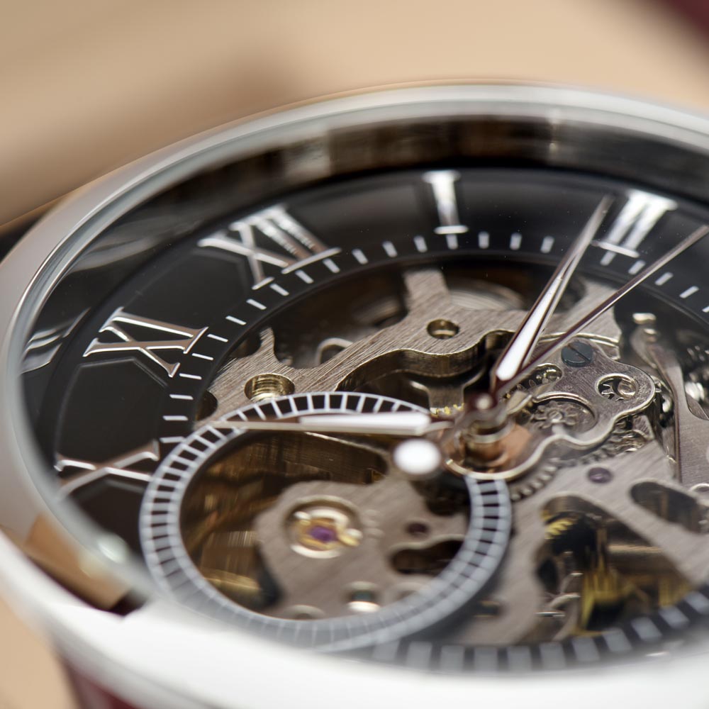 Close-up of openwork skeleton watch dial showing the intricate mechanical movement