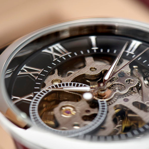 Close-up of openwork skeleton watch dial showing the intricate mechanical movement
