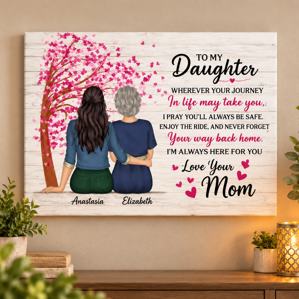 Personalized canvas wall art featuring a printed message for a daughter, with an illustration of two women from behind under a pink cherry blossom tree. The text includes customizable names 'Anastasia' and 'Elizabeth' and the phrase 'Love Your Mom.