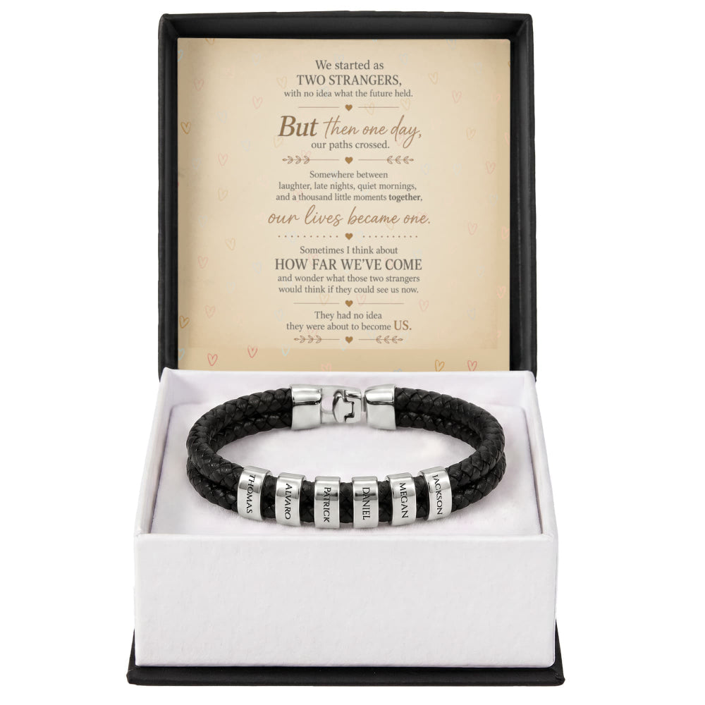 A black braided leather bracelet with silver letter beads engraved with 'LOVE' and 'faith', presented in an open gift box with a sentimental poem card inside.