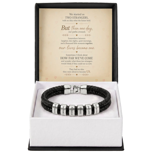 A black braided leather bracelet with silver letter beads engraved with 'LOVE' and 'faith', presented in an open gift box with a sentimental poem card inside.