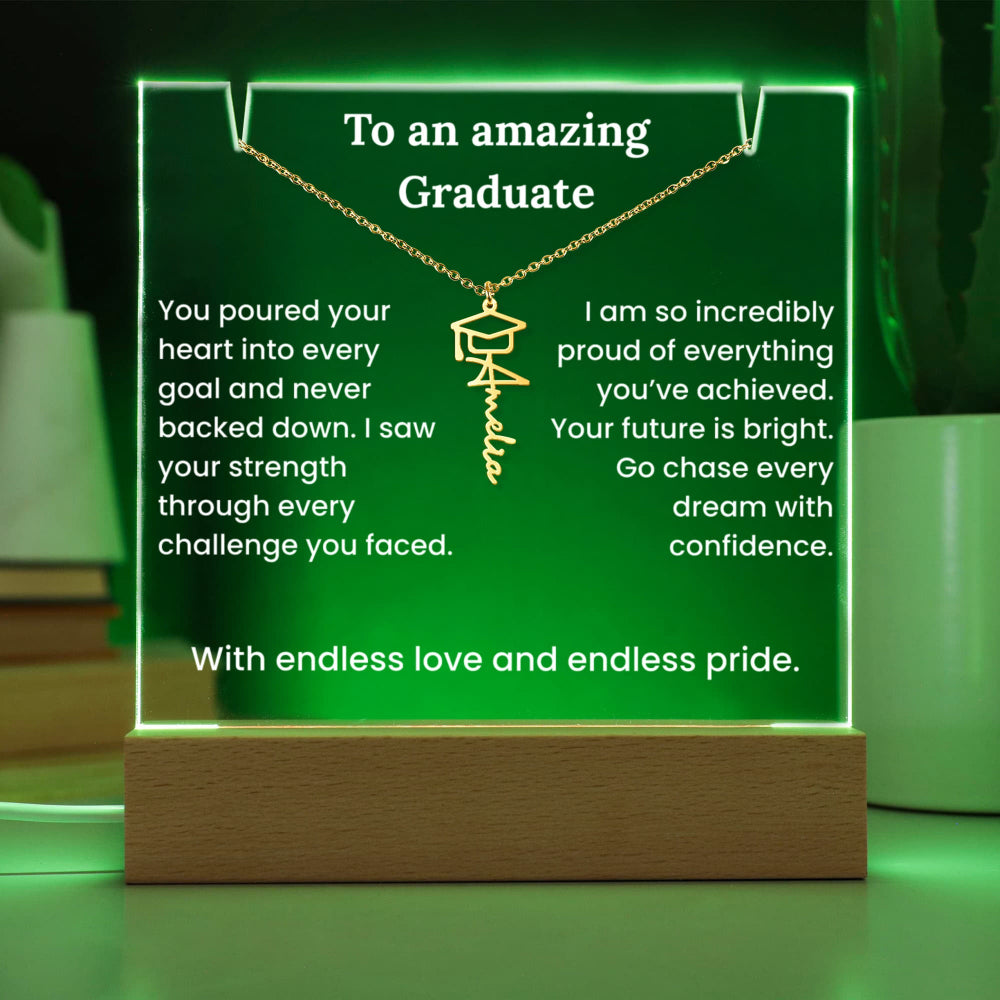 Acrylic plaque with a necklace and graduation message on a green background