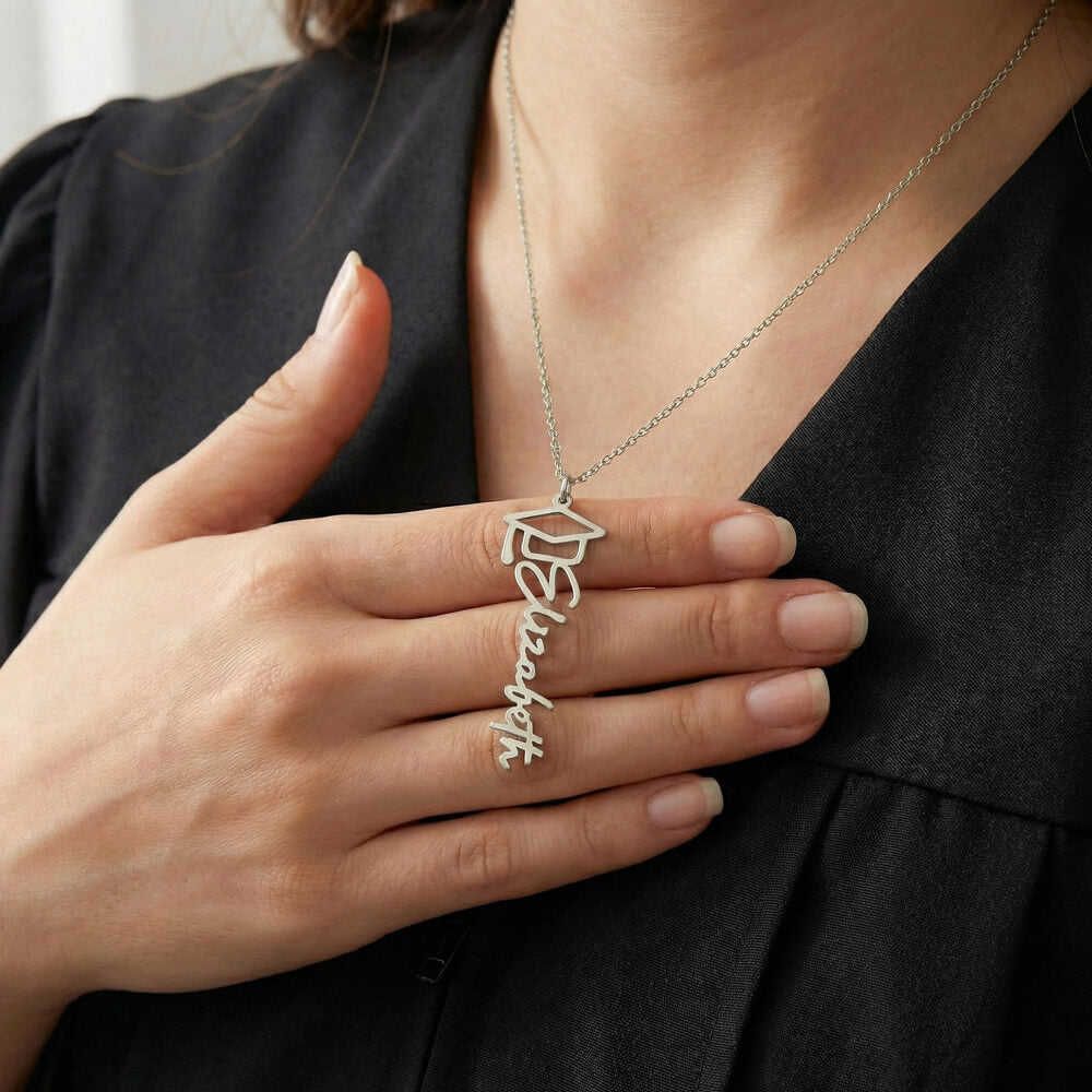 Graduation name necklace for daughter in polished stainless steel with graduation cap detail