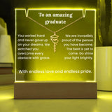 Luminous plaque with engraved message for a graduate, featuring a necklace with a graduation cap pendant.