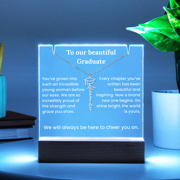 Decorative sign with a necklace design and graduation message on a blue background