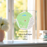 Personalized map in a glass frame on a windowsill with flowers and books in the background