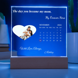 Personalized calendar with a heart-shaped photo of a family on a blue background