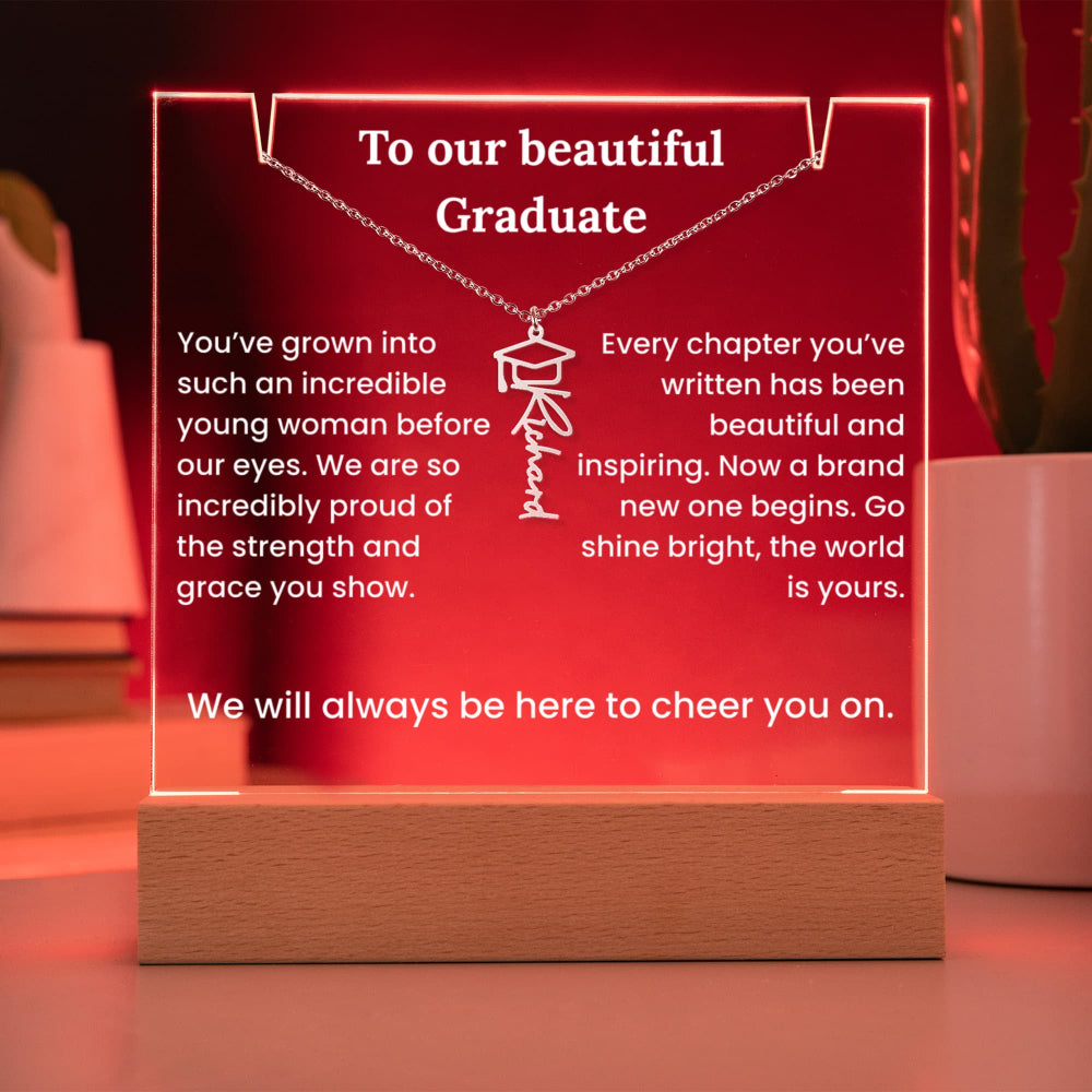 Decorative plaque with engraved message and necklace design on a wooden base.