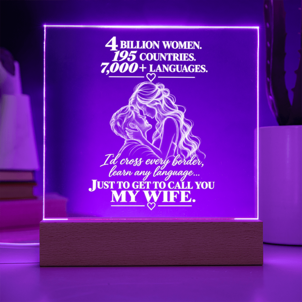 A rectangular acrylic LED lamp glowing with purple light on a wooden base, featuring white engraved text and an illustration of a couple with hearts. The message reads, 'I CHOSE YOU without knowing where life would take us.