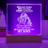 A rectangular acrylic LED lamp glowing with purple light on a wooden base, featuring white engraved text and an illustration of a couple with hearts. The message reads, 'I CHOSE YOU without knowing where life would take us.