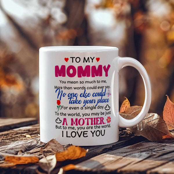 White 11oz mug with a heartfelt message to 'Mommy' on a wooden surface with autumn leaves.