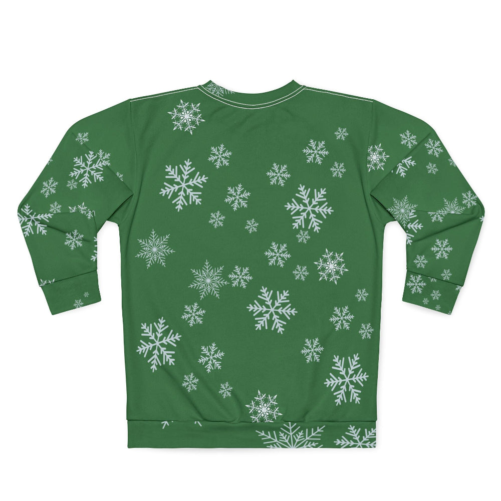 Green sweatshirt with white snowflake pattern on a white background