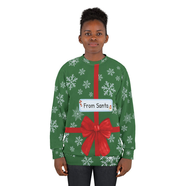 Person wearing a green Christmas-themed sweater with a red bow and 'From Santa' label.