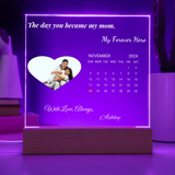 Personalized calendar with a heart-shaped photo of a family and text on a purple background