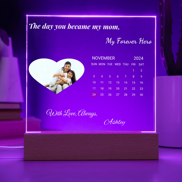 Personalized calendar with a heart-shaped photo of a family and text on a purple background