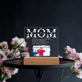 Acrylic plaque with 'MOM' text and photo of a child on a stand with flowers in the background